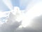 dense white clouds in backlight under blue sky