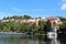 Densely built traditional mountain houses of small mountain town next to fresh water lake surrounded with trees and other forest