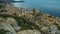 Densely built-up seaside town at small harbor, view from mountain top, timelapse