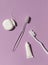Dental care concept composition with toothbrush, tooth floss and toothpaste on the violet background.
