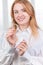 Dental care.Smiling girl with braces on her teeth holds aligners in her hands and shows the difference between them