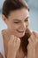 Dental care. Smiling woman cleaning white teeth with floss