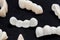 Dental ceramic or zirconium tooth bridges on dark black surface.