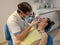 Dental clinic. Dentist\'s office. The doctor prosthetics the teeth of an adult woman