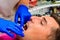 Dental clinic, the patient sits in a dental chair with his mouth wide open, the dentist assesses the condition of the teeth and