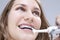 Dental Concept and Ideas. Extreme Closeup Portrait of Caucasian Teenage Girl Brushing Teeth Brackets with Electric Toothbrush