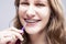 Dental Concepts. Portrait of Teenage Girl Using Bristle Brush for Cleaning Braces and Teeth