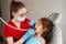 Dental drill. Child dentist drilling teeth of kid girl in dentistry clinic. Dental filling for child patient.