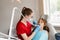 Dental drill. Child dentist drilling teeth of kid girl in dentistry clinic. Dental filling for child patient.