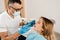 Dental drill. Dentist drilling teeth of woman in dentistry clinic. Dental filling for girl patient.