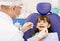 Dental examining being given to little girl by dentist