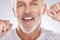 Dental, floss and face of senior man in studio isolated on a gray background. Portrait, cleaning or elderly male model