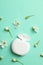 Dental floss and flowers on mint background