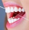 Dental floss. Oral hygiene and health care. Smiling women use dental floss white healthy teeth. Dental flush - woman