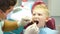 Dental health concept. Male dentist treating little boy in dental clinic. Pediatric dentistry. Dentist examines teeth of