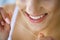 Dental Health. Woman With Beautiful Smile Flossing Healthy Teeth