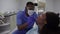 Dental and healthcare concept. Professional african american male dentist in blue medical suit, mask glasses and