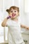 Dental hygiene. Smiling child girl brushing her teeth