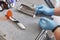 Dental instruments close up. The dentist wears blue gloves. Dental treatment