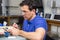 Dental lab technician appying porcelain to mold