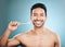 Dental, portrait and Asian man with a toothbrush, oral hygiene and wellness against a blue studio background. Face, male