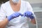 Dental saliva pump in the hands of an assistant. Hands in protective gloves. Concept of health care and disease prevention. Dental