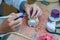 A dental technician makes partial dentures. The production of false teeth or dental bridges. Close-up.