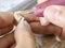 Dental technician modelling an implant ceramic tooth with a drill