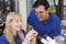 Dental technician showing a prosthesis to a collegue