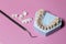 Dental tool and Zircon dentures on a pink background - Ceramic veneers - lumineers