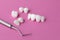 Dental tool and Zircon dentures on a pink background - Ceramic veneers - lumineers