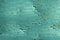 Dented texture of a scratched steel turquoise metal surface