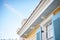 dentil moldings on eaves of a classic georgian home with blue shutters