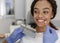 Dentist applying sample from tooth scale to patient teeth