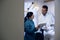 Dentist and assistant checking documents in dental studio