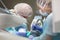 Dentist and assistant during work. Removal of caries under General anesthesia in a child. Copy of the space