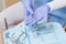 Dentist in blue scrubs holding dental tools