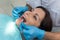 Dentist comparing patient`s teeth color with sampler