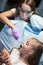 Dentist curing a child patient in the dental office