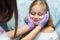 Dentist curing a child patient in the dental office