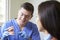 Dentist Demonstrating Correct Use Of Toothbrush To Female Client