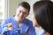 Dentist Demonstrating Correct Use Of Toothbrush To Female Client