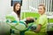 Dentist in dental office talking with female patient and preparing for treatment