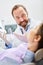 Dentist discusses treatment with patient