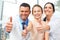 Dentist doctor, assistant and little girl all smiling at camera