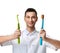 Dentist doctor dental hygienists compare two big tooth brushes