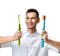 Dentist doctor dental hygienists compare two big tooth brushes