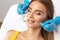 A dentist doctor treats caries on a tooth of a young beautiful woman in a dental clinic. Tooth filling