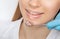 A dentist doctor treats caries on a tooth of a young beautiful woman in a dental clinic. Tooth filling