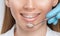 A dentist doctor treats caries on a tooth of a young beautiful woman in a dental clinic. Tooth filling